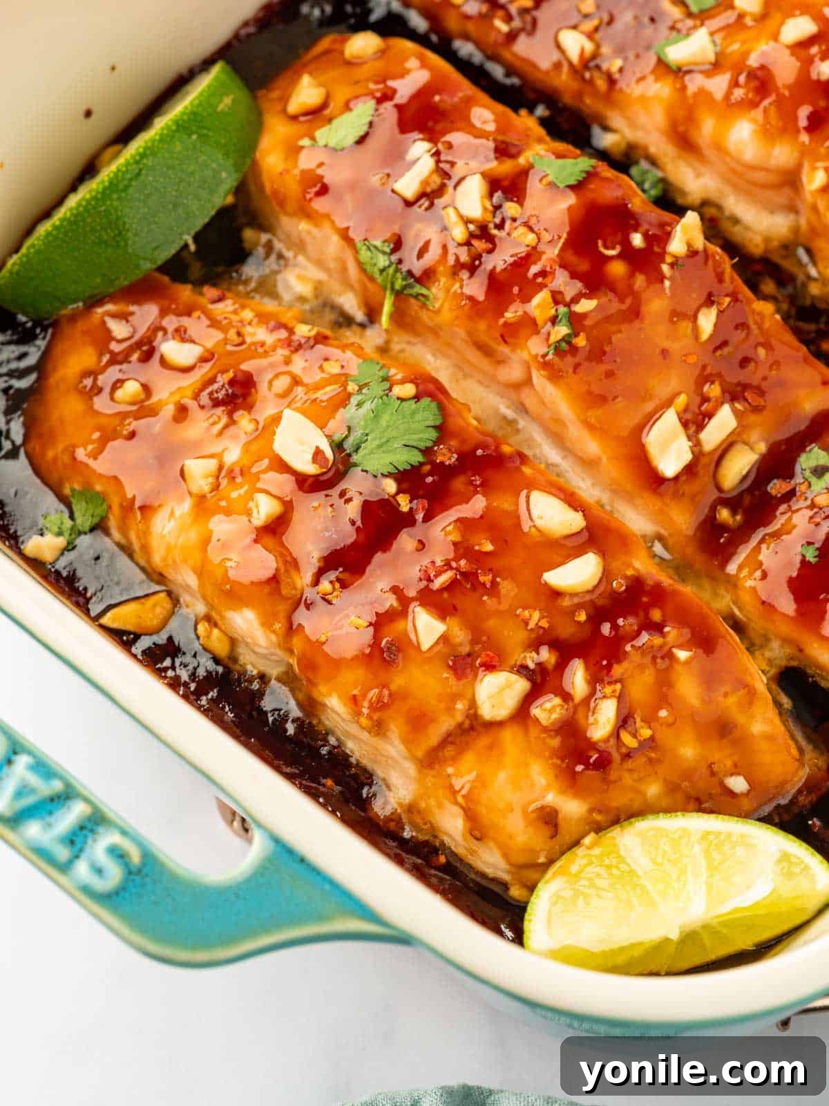 Thai Chili-Lime Baked Salmon 8 A close-up of baked Thai salmon in a baking dish, showcasing its moist, flaky texture and the delicious marinade.