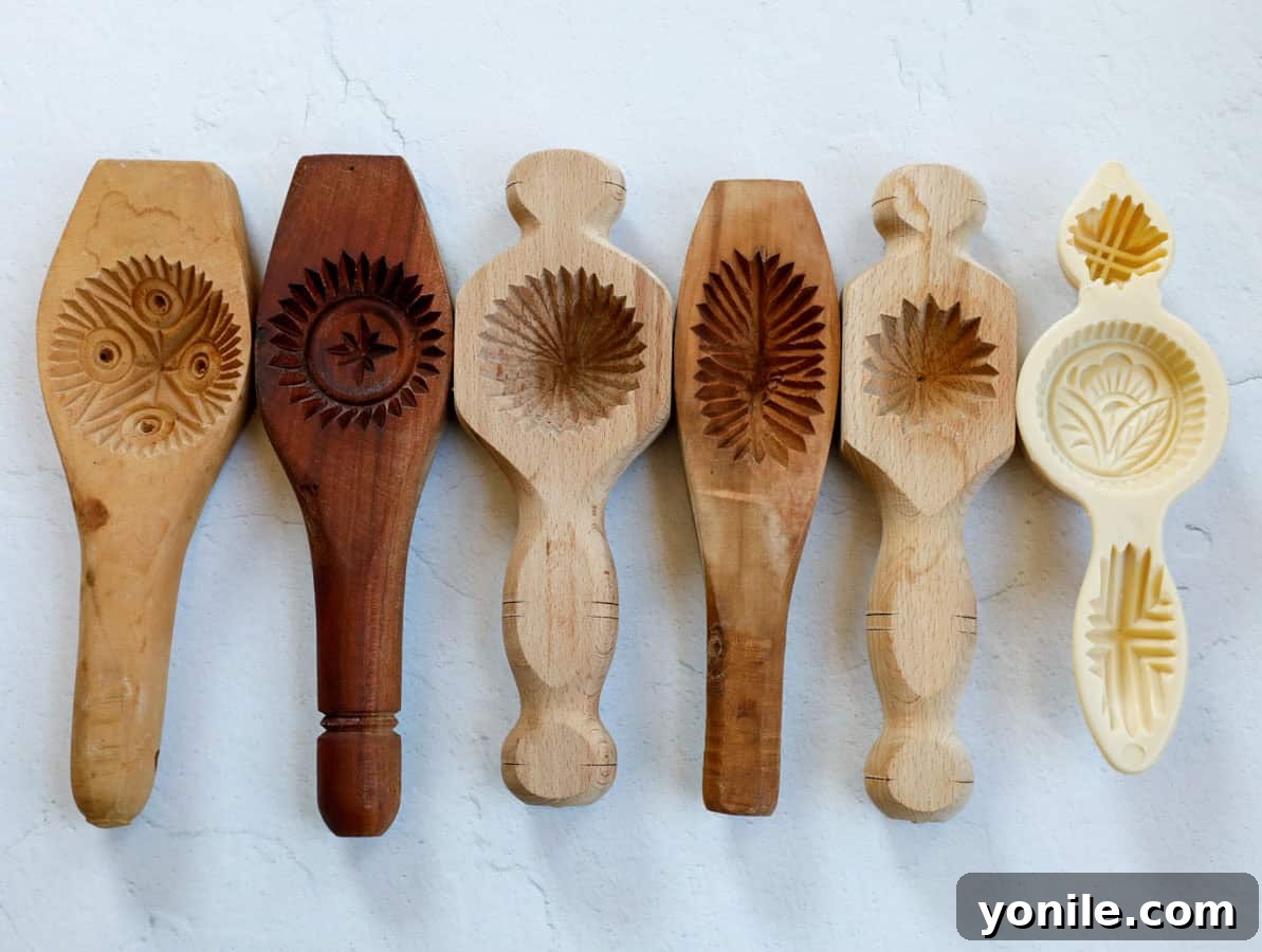 Maamoul Irresistible Date Cookies 15 A collection of various traditional maamoul molds made of wood.