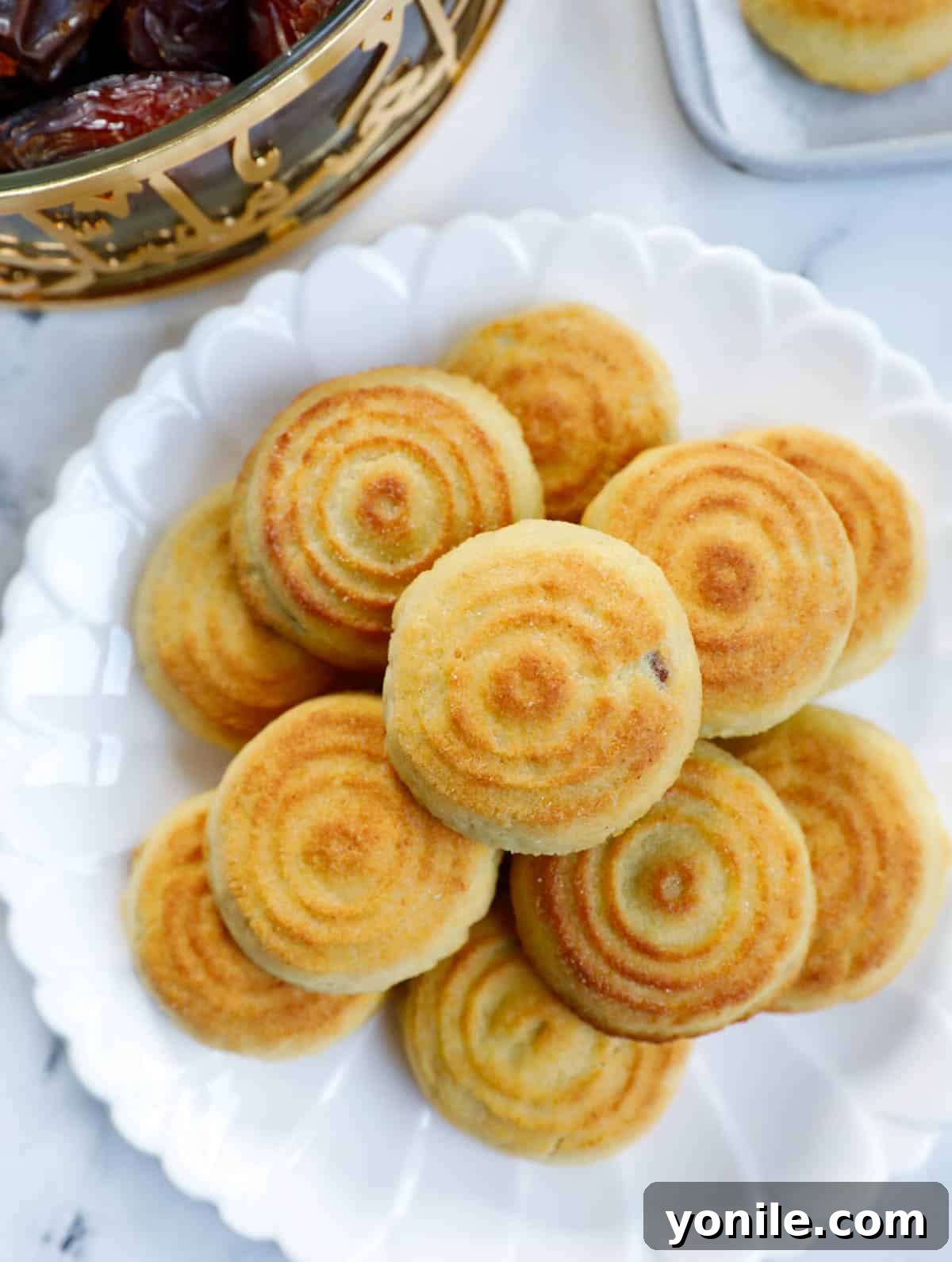 Maamoul Irresistible Date Cookies 16 A plate brimming with delicious date filled maamoul cookies, ready to be enjoyed.
