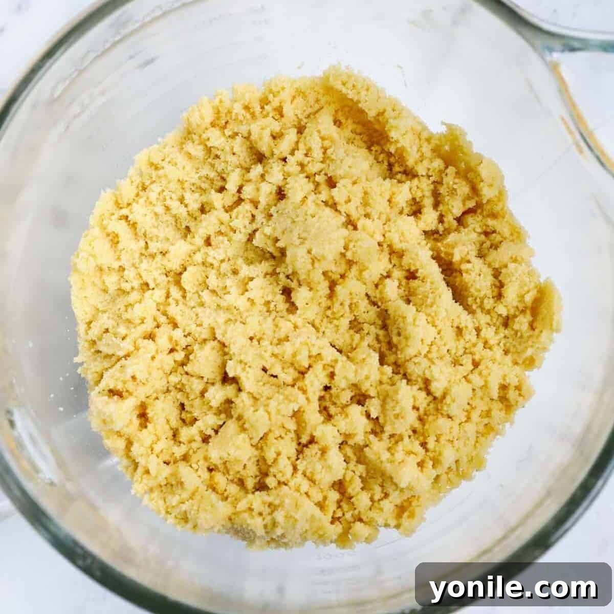 Maamoul Irresistible Date Cookies 5 The semolina mixture for maamoul in a bowl, appearing smooth and sandy after its overnight rest.