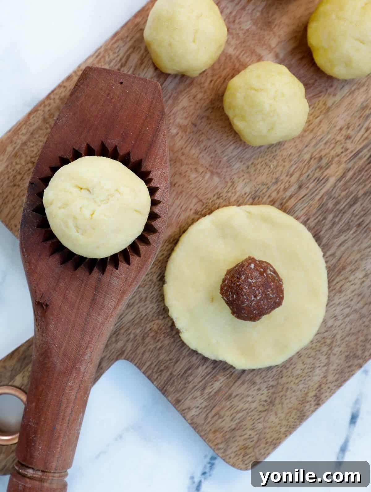 Maamoul Irresistible Date Cookies 10 A visual sequence showing Maamoul dough being flattened, a date ball placed on it, and the finished cookie in a mold.