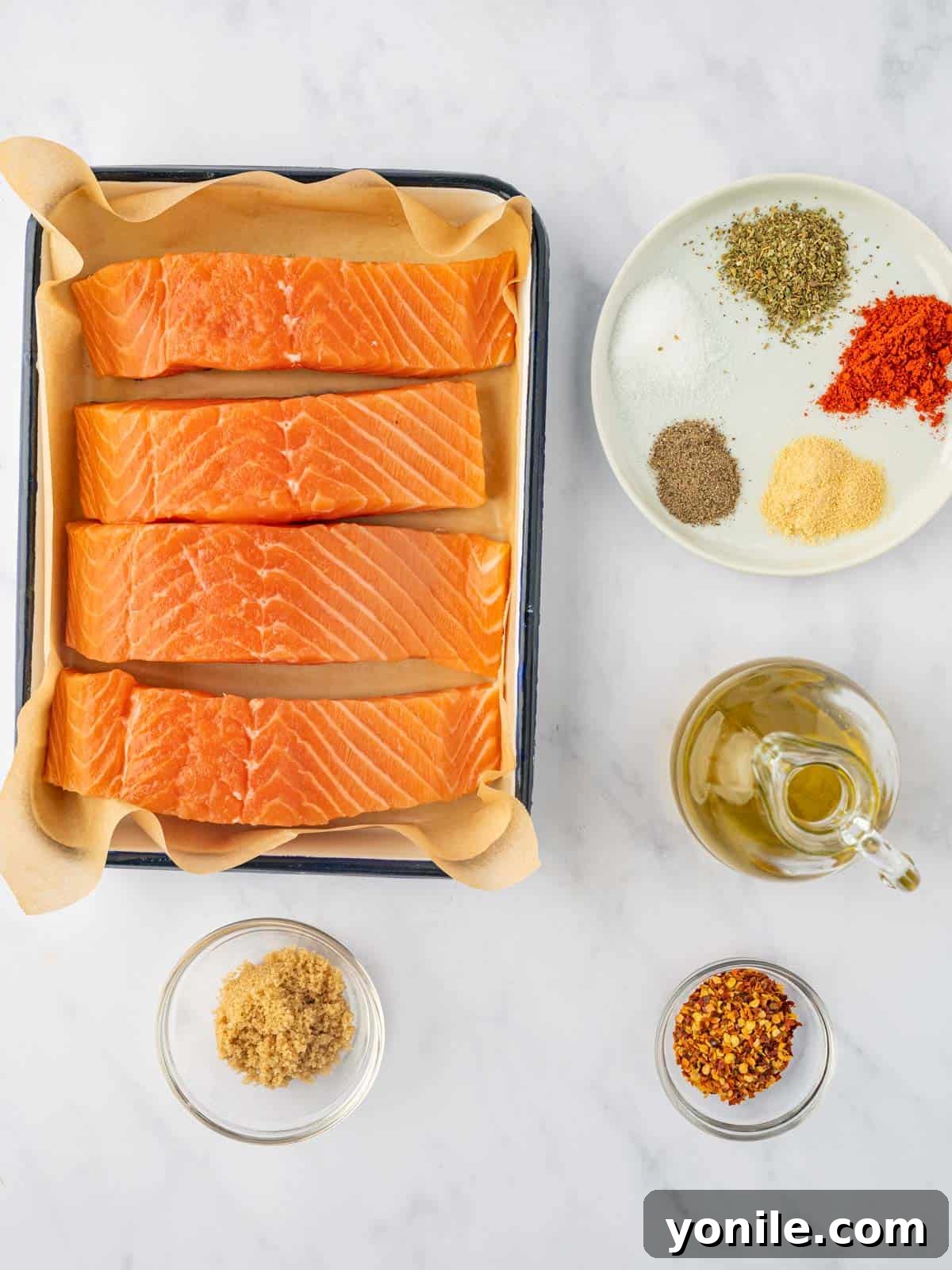 Sweet & Sticky Brown Sugar Salmon 3 Ingredients for brown sugar baked salmon, including salmon fillets, spices, and lemon.