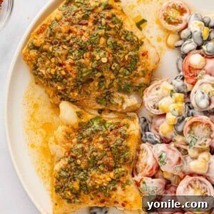 Finished cod fillets with herbs and lime.