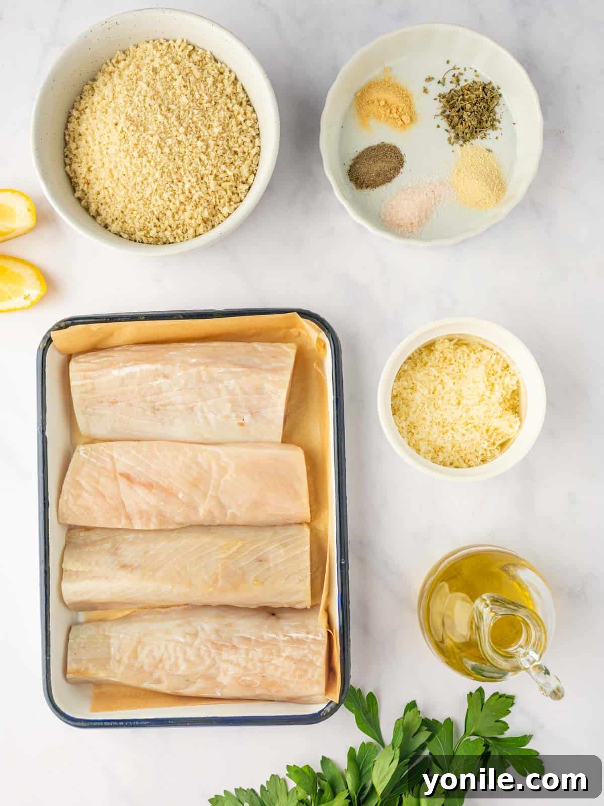 Ingredients for air-fried Mahi Mahi fish, including fillets, panko breadcrumbs, Parmesan cheese, and various spices arranged neatly.