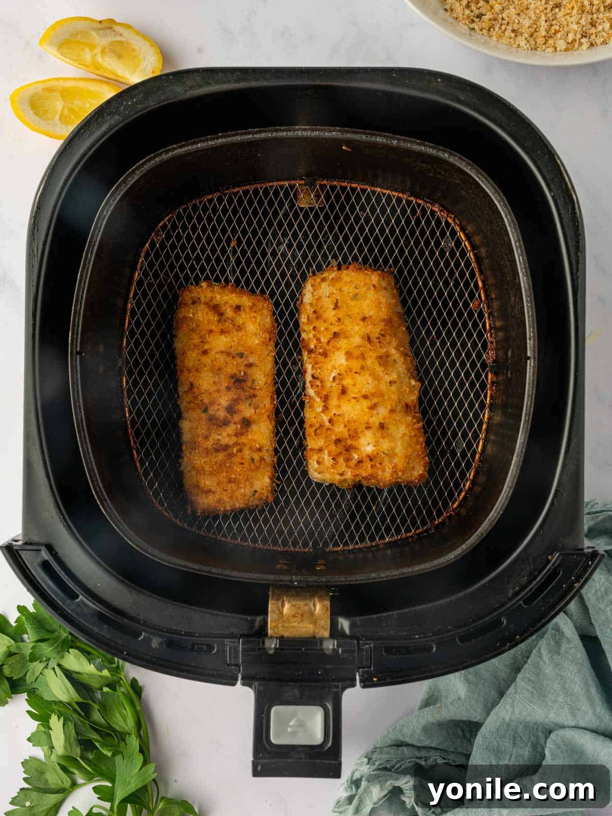 Crispy, golden-brown breaded Mahi Mahi fish fillets perfectly cooked in the air fryer, ready to be served.