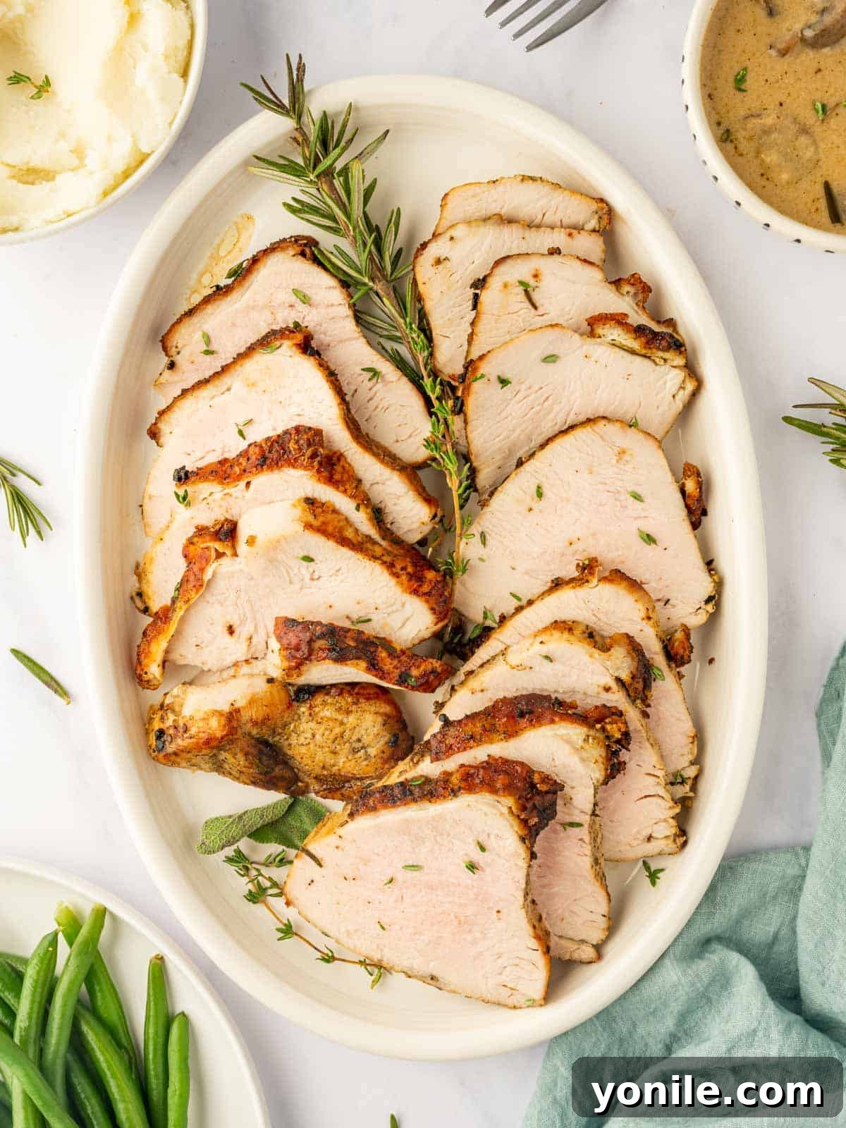 A platter of turkey breast slices, perfectly cooked and ready to serve.