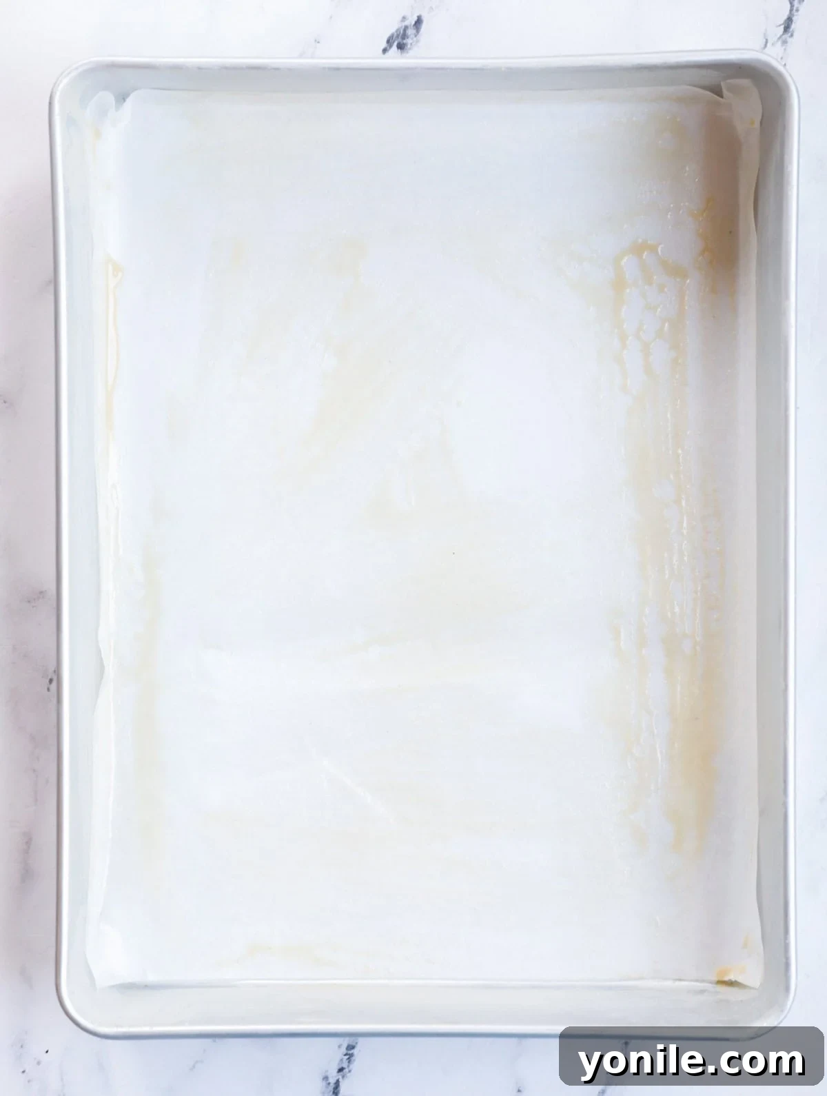 Cake pan brushed with tahini paste.