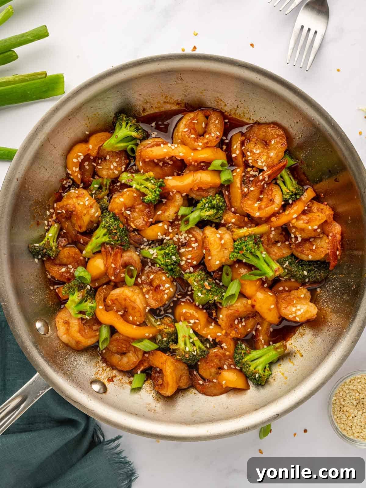 Sticky Sweet Chili Glazed Shrimp 2 Sweet chili shrimp sizzling in a skillet, ready to be served over rice.