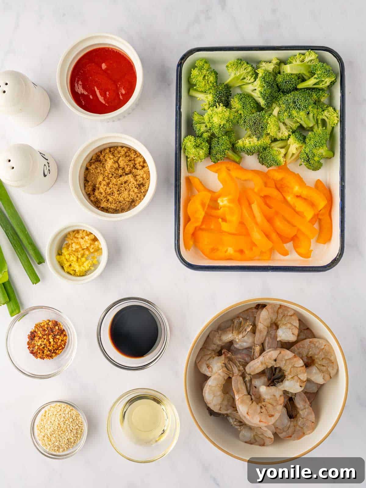 Sticky Sweet Chili Glazed Shrimp 3 All the fresh ingredients laid out for making sweet chili shrimp, including shrimp, broccoli, bell pepper, and sauce components.