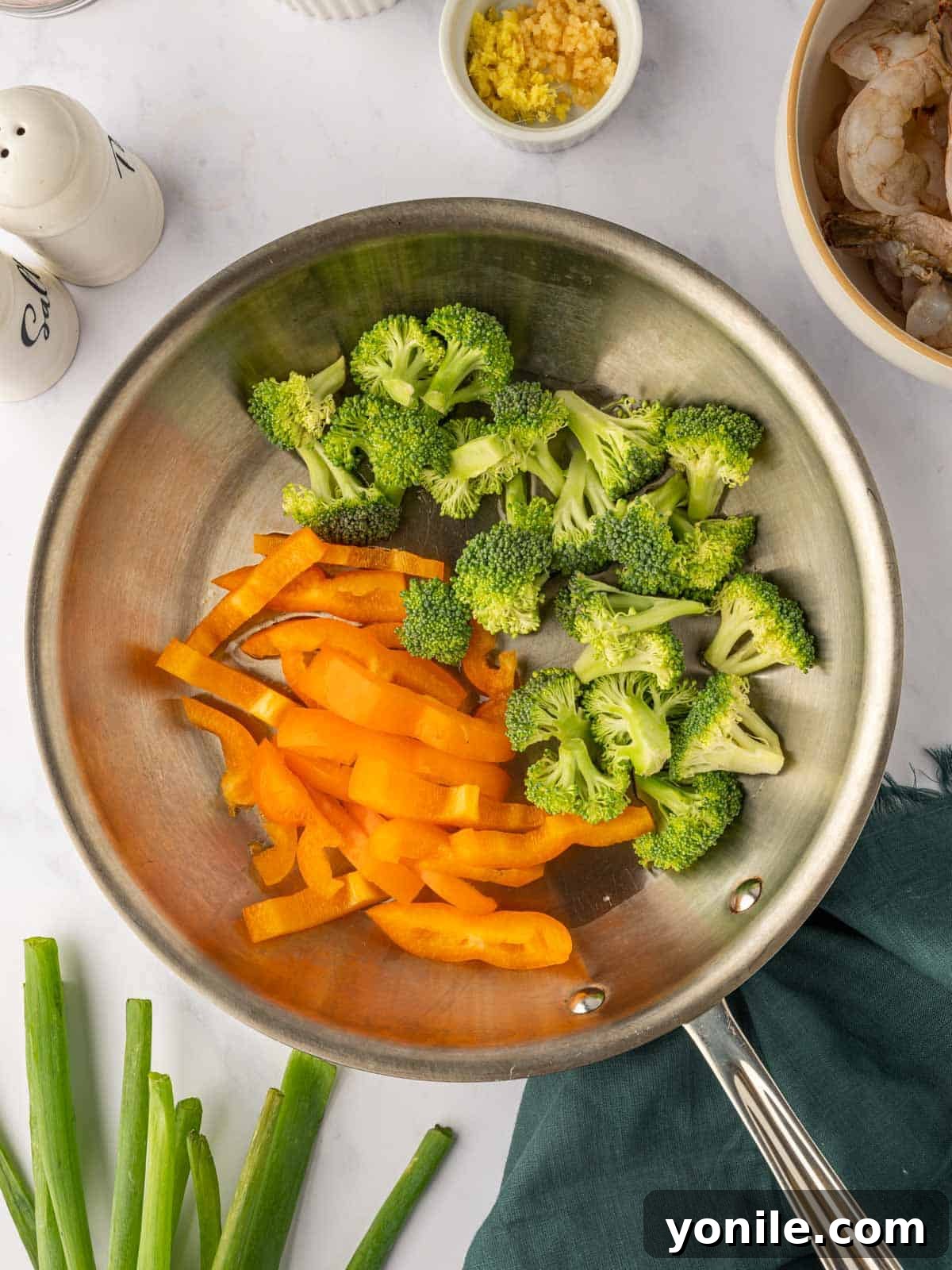 Sticky Sweet Chili Glazed Shrimp 5 Fresh broccoli and bell peppers stir-frying in a skillet, turning tender-crisp.