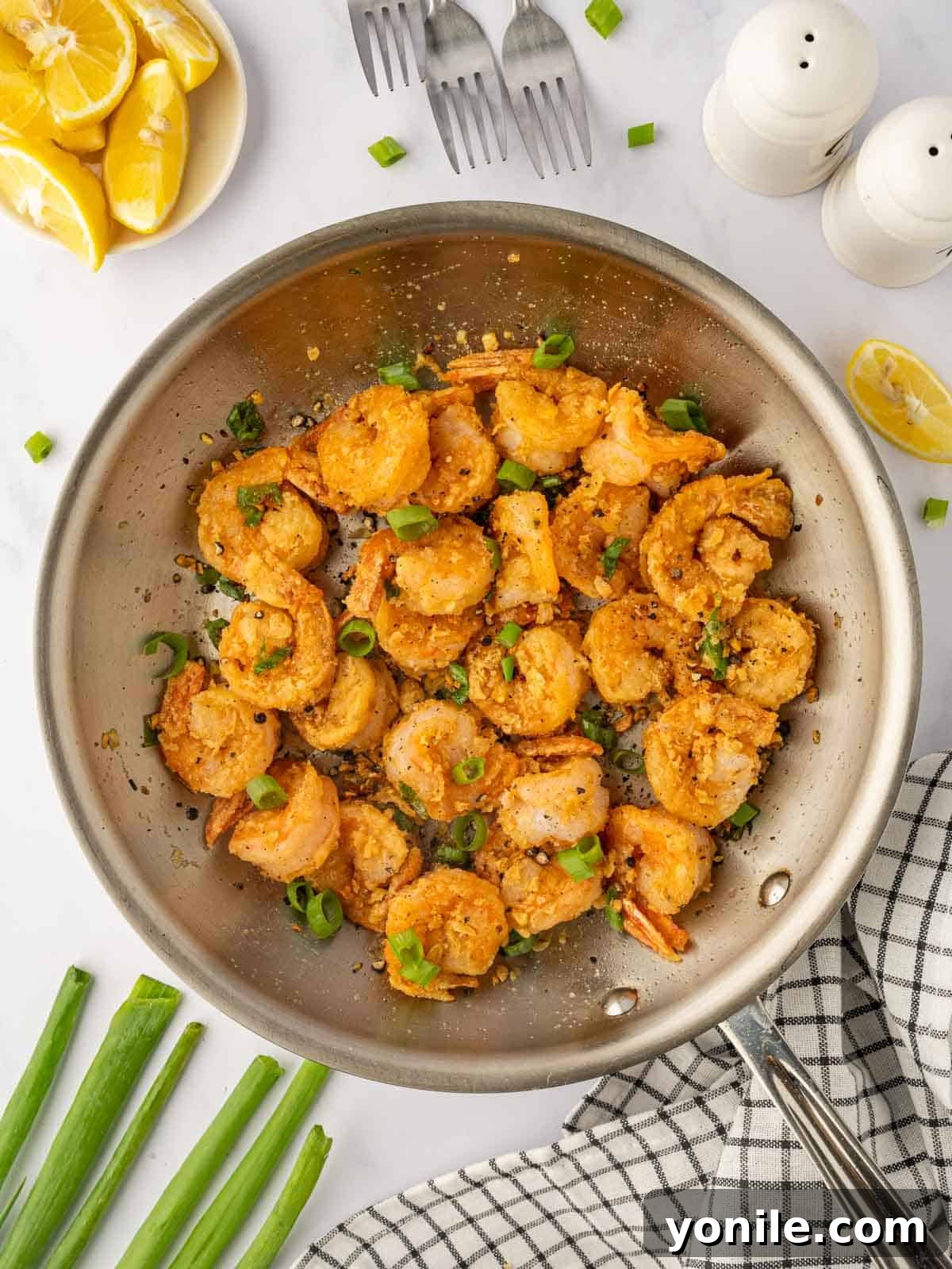 Crispy Salt and Pepper Shrimp perfectly stir-fried in a hot skillet, ready to be served.