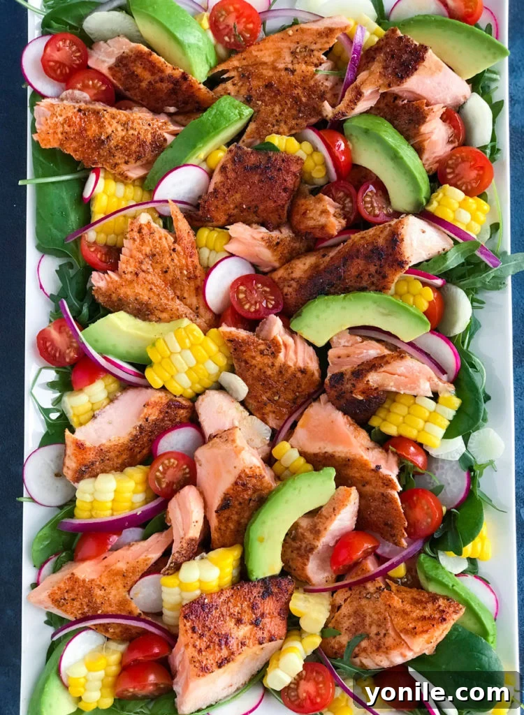 A large platter showcasing the colorful and healthy spicy salmon salad ingredients.