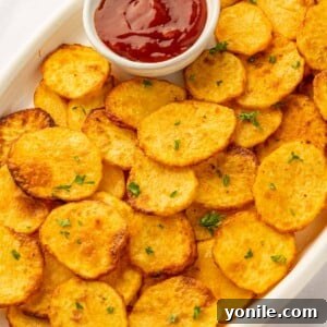 Crispy air fryer sliced potatoes on a platter, ready to be served.