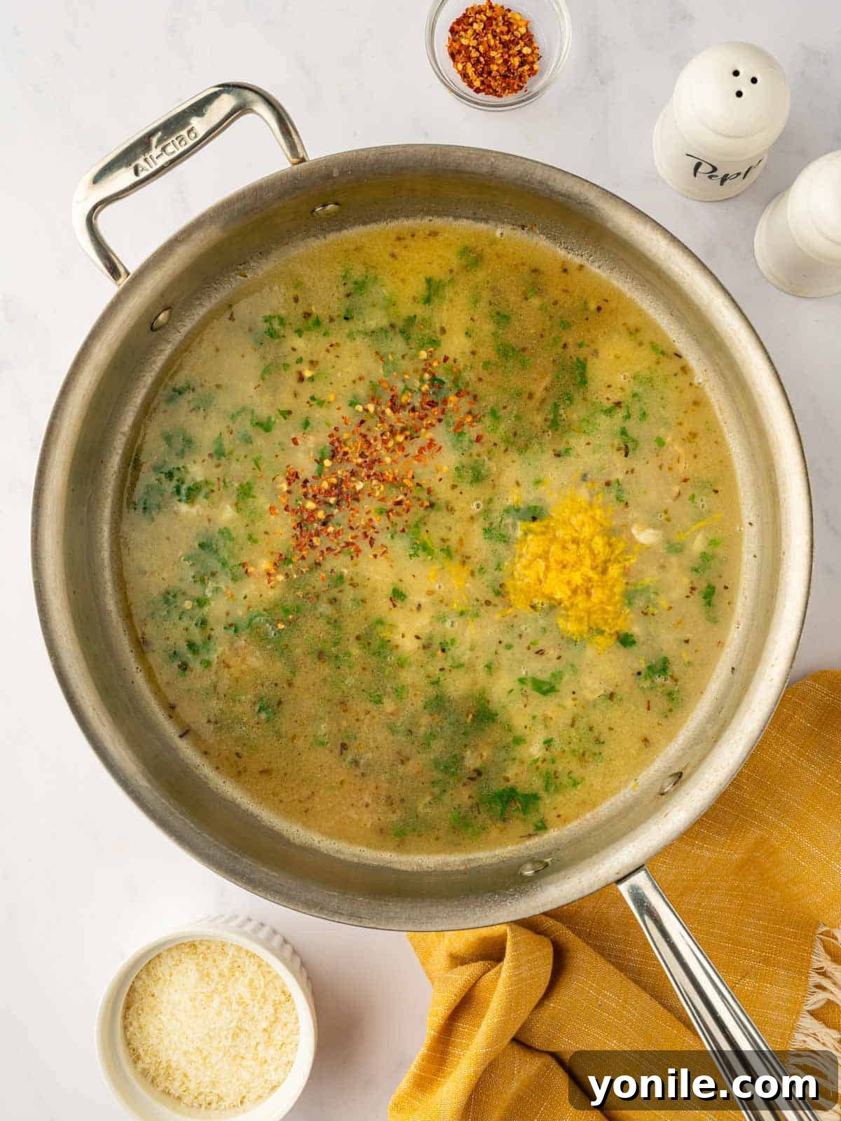 Adding herbs and seasonings to the skillet.
