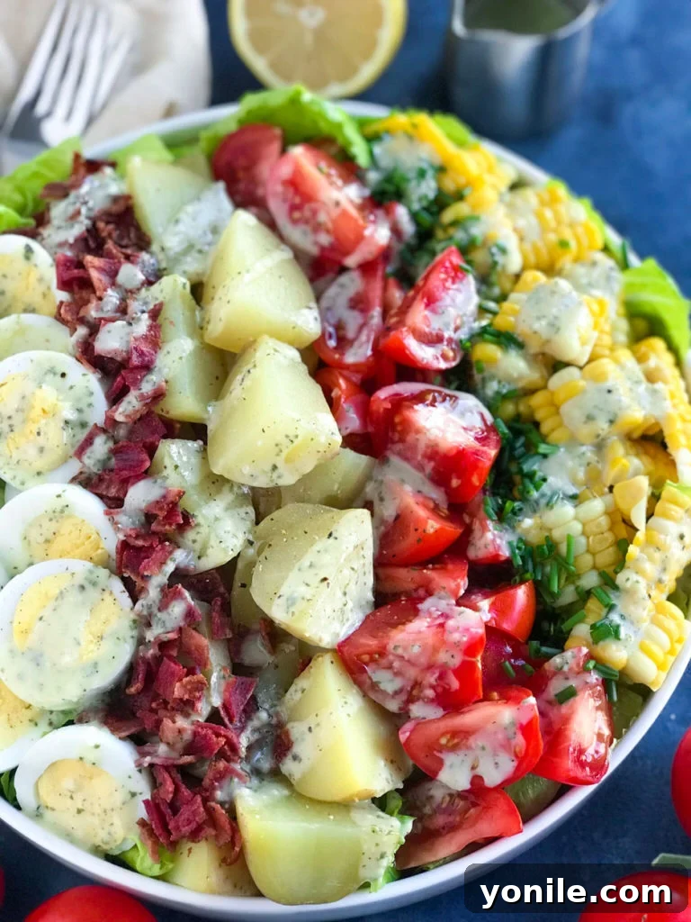 Potato Cobb Salad The salad with dressing drizzled on it