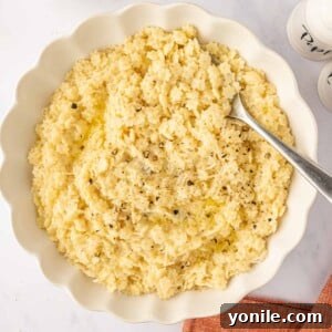 Italian Pastina Comfort 9 A spoon rests in a white bowl of pastina pasta.