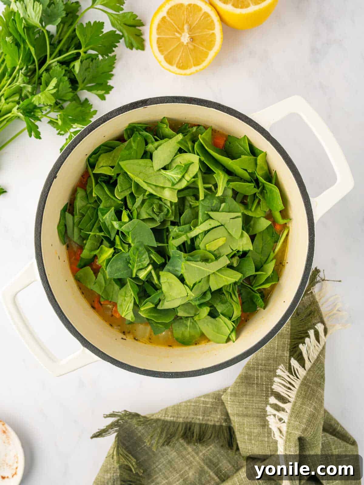 Chopped spinach is added to the broth.