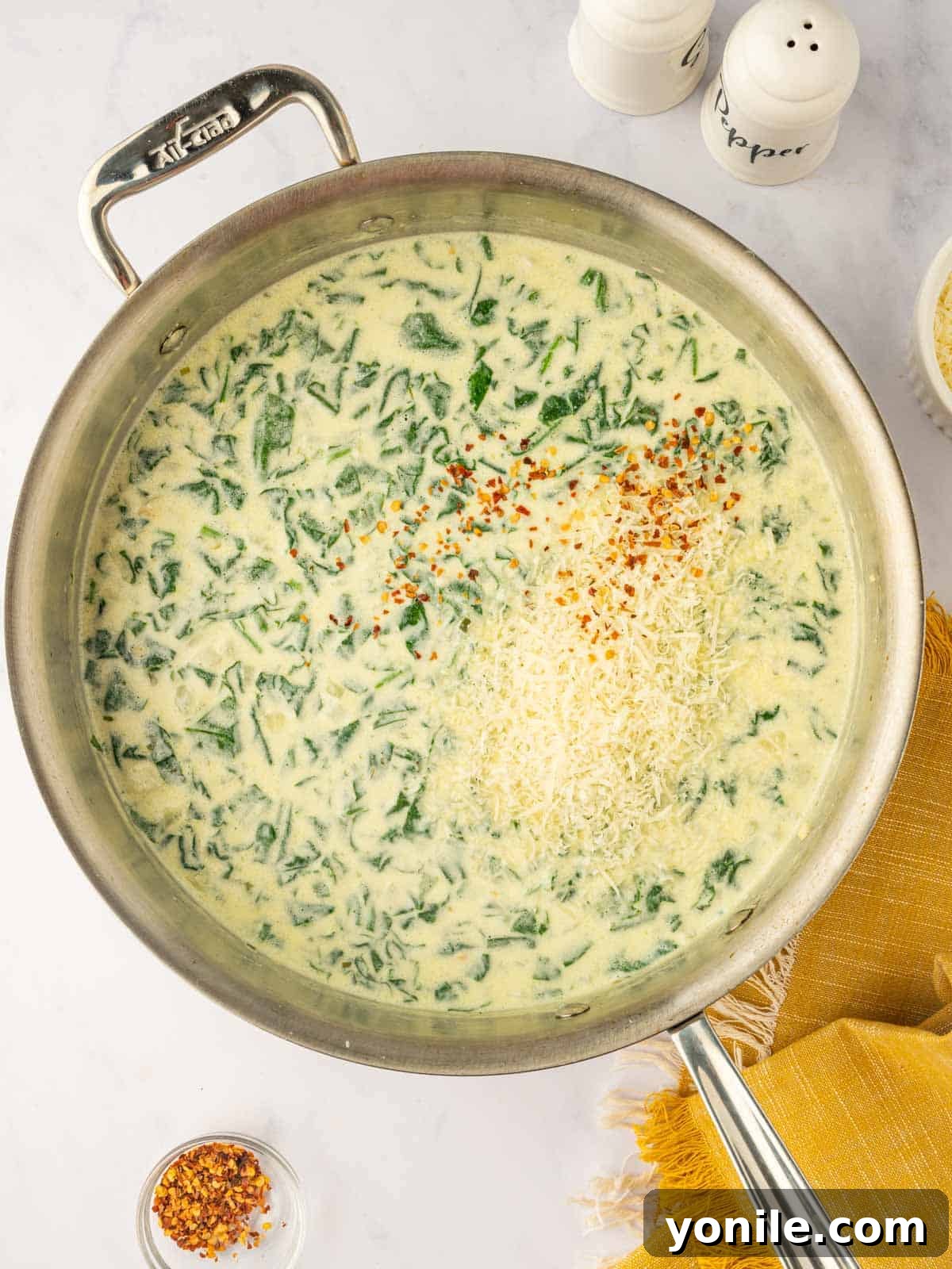 Stir parmasan cheese and pepper into cheese sauce.
