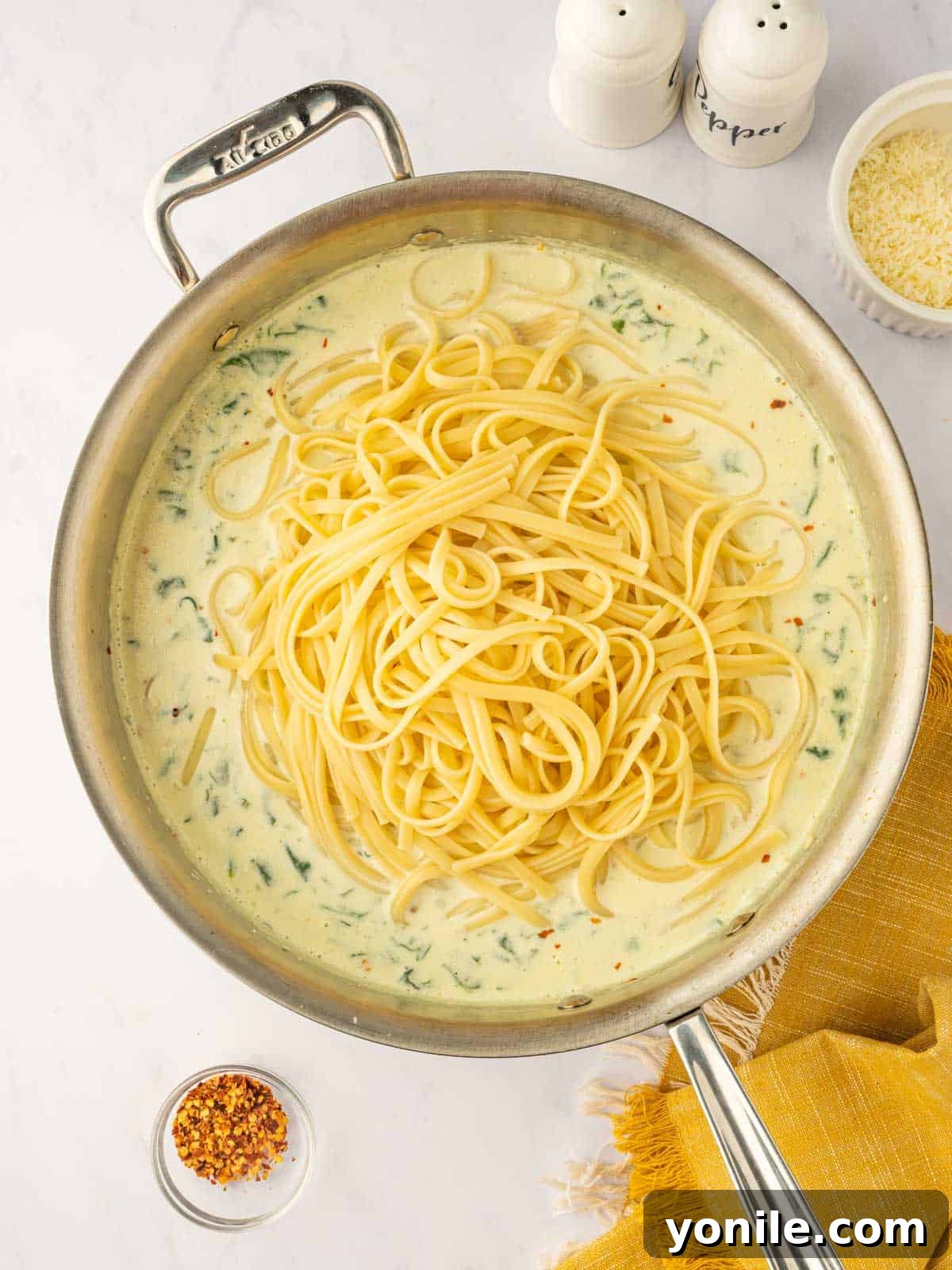 Cooked pasta is tossed into the sauce.