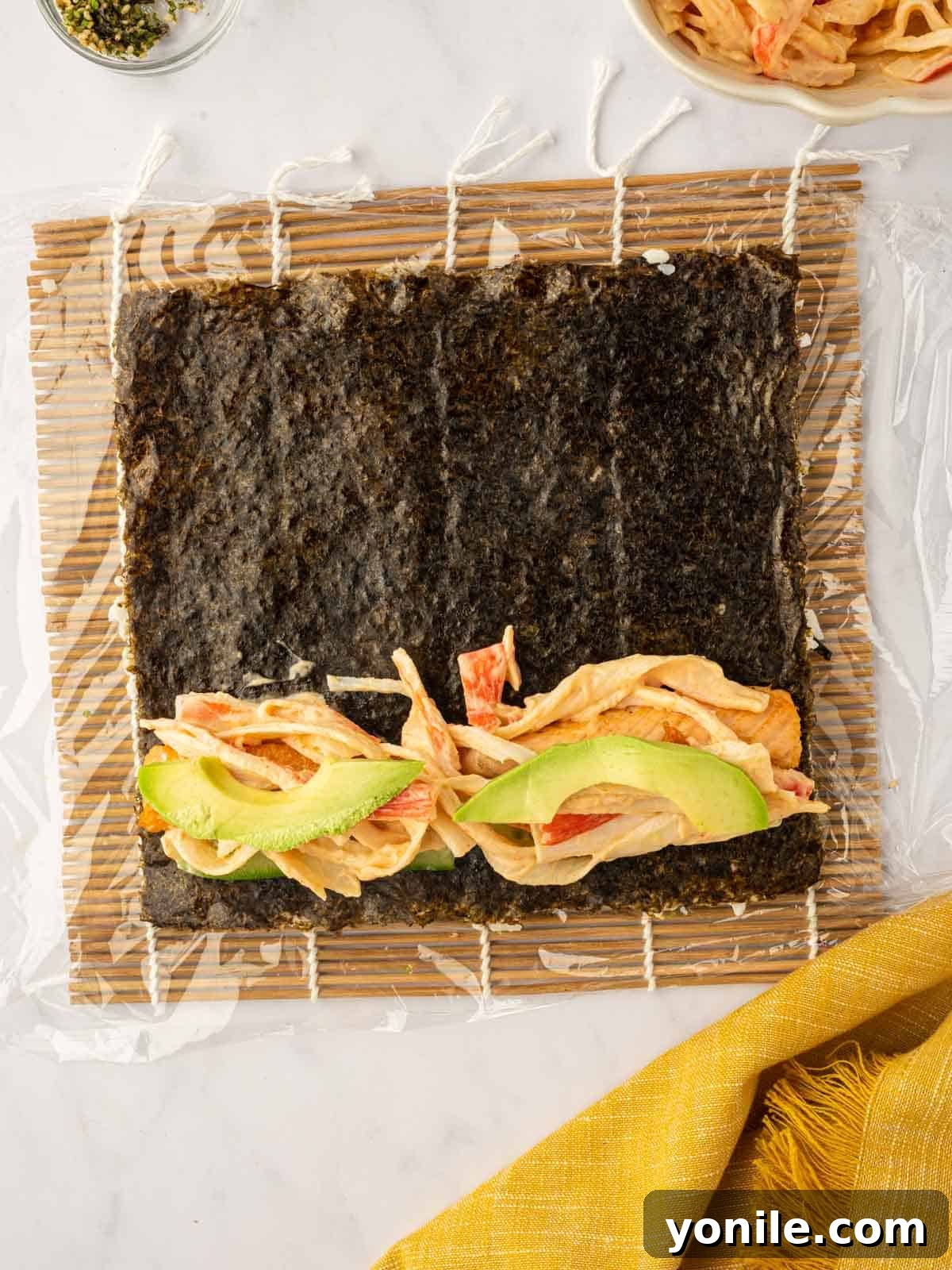 Dynamite Salmon Roll 13 Slices of creamy avocado are added as the final filling layer to the sushi roll.