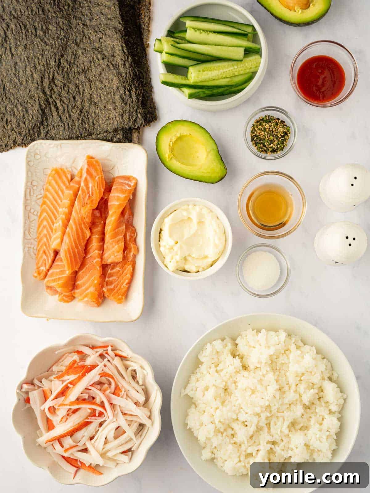 Dynamite Salmon Roll 3 All the fresh ingredients meticulously laid out for making spicy salmon sushi roll.