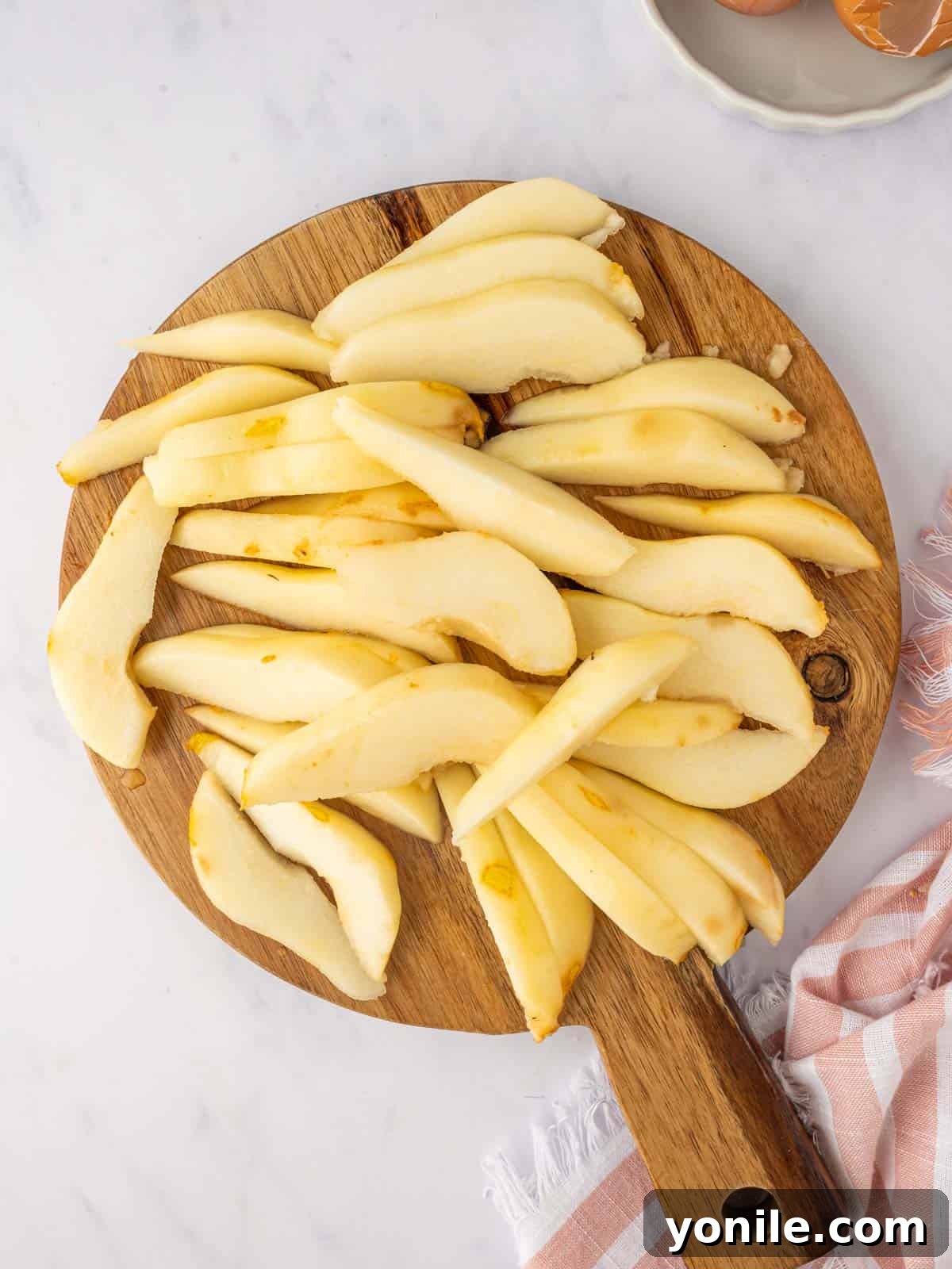Fresh pears are meticulously sliced into even, appealing pieces.