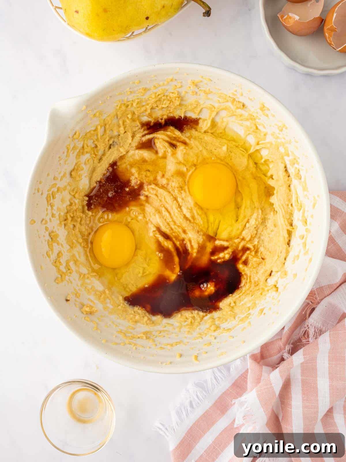 The smooth, pale cake batter is prepared in a large mixing bowl.