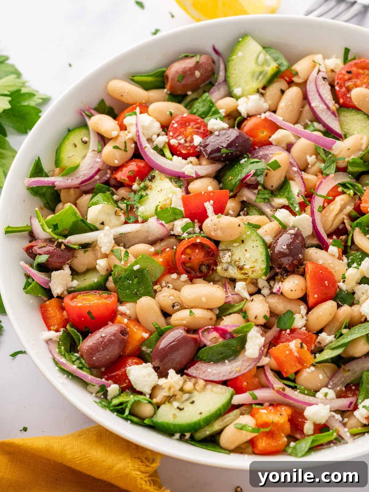 Closeup of Mediterranean bean salad. A detailed close-up shot of the Greek white bean salad, highlighting the texture and freshness of the beans, vegetables, and feta cheese.