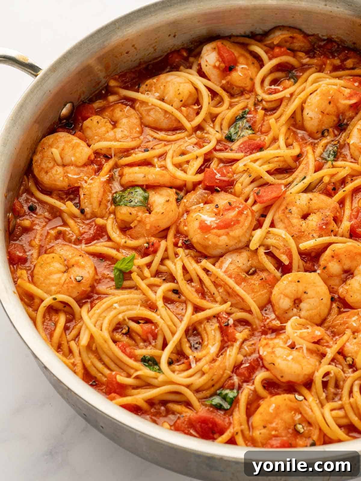 Prawn Pasta Perfection 12 A tantalizing close-up shot of a skillet filled with shrimp pasta, highlighting the textures and vibrant sauce.