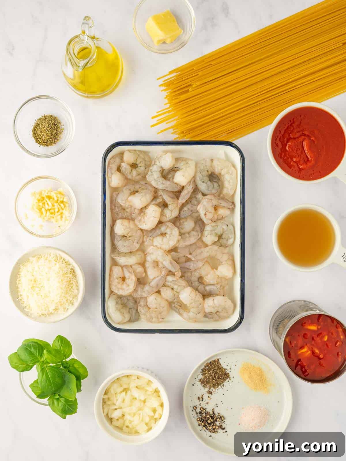 Prawn Pasta Perfection 3 All the fresh ingredients required to make delicious shrimp spaghetti laid out on a table.