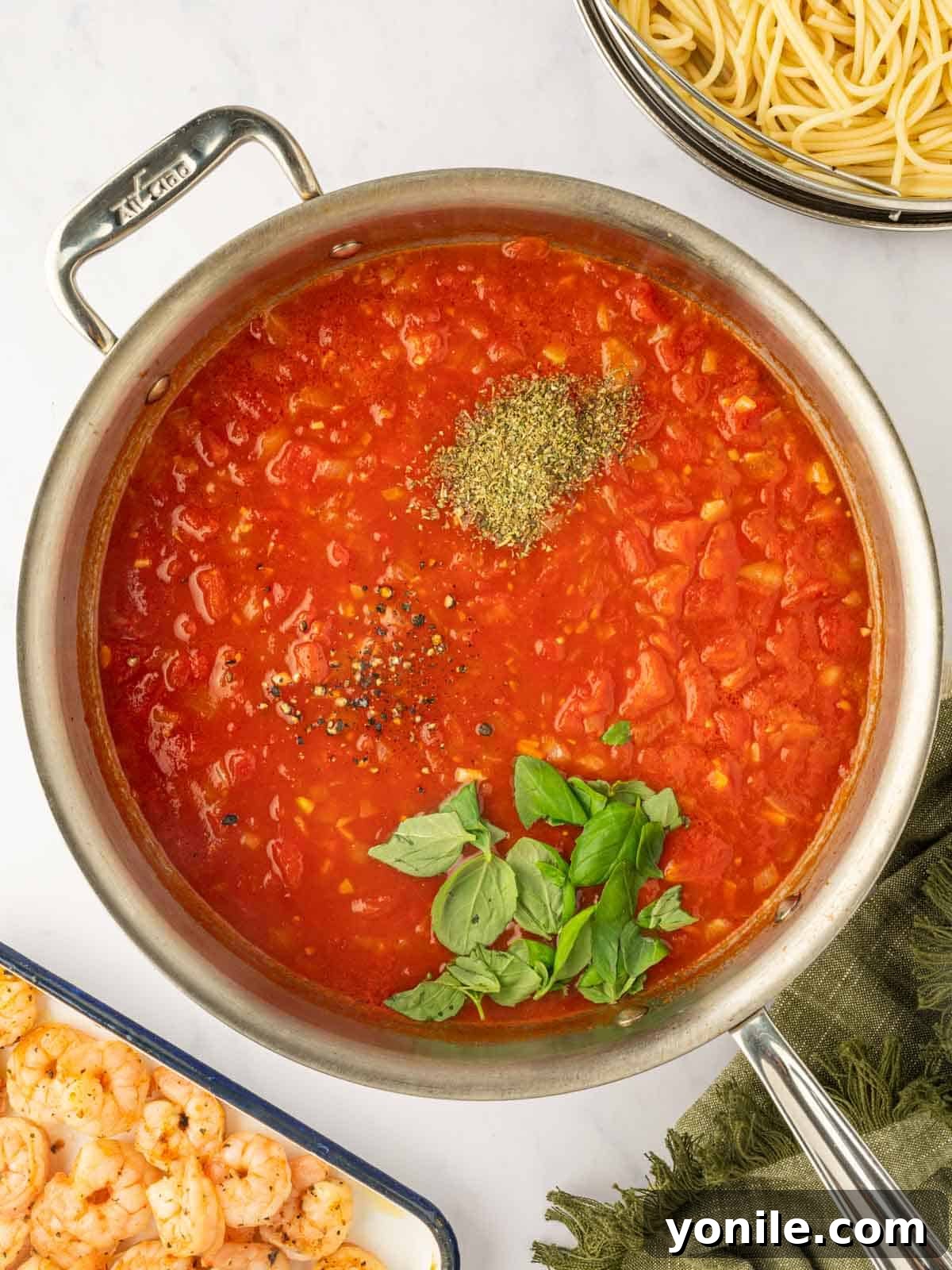 Prawn Pasta Perfection 8 Incorporating fresh basil and Italian seasonings into the simmering tomato sauce.