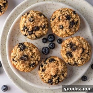 Oatmeal cups with blueberries on a plate.