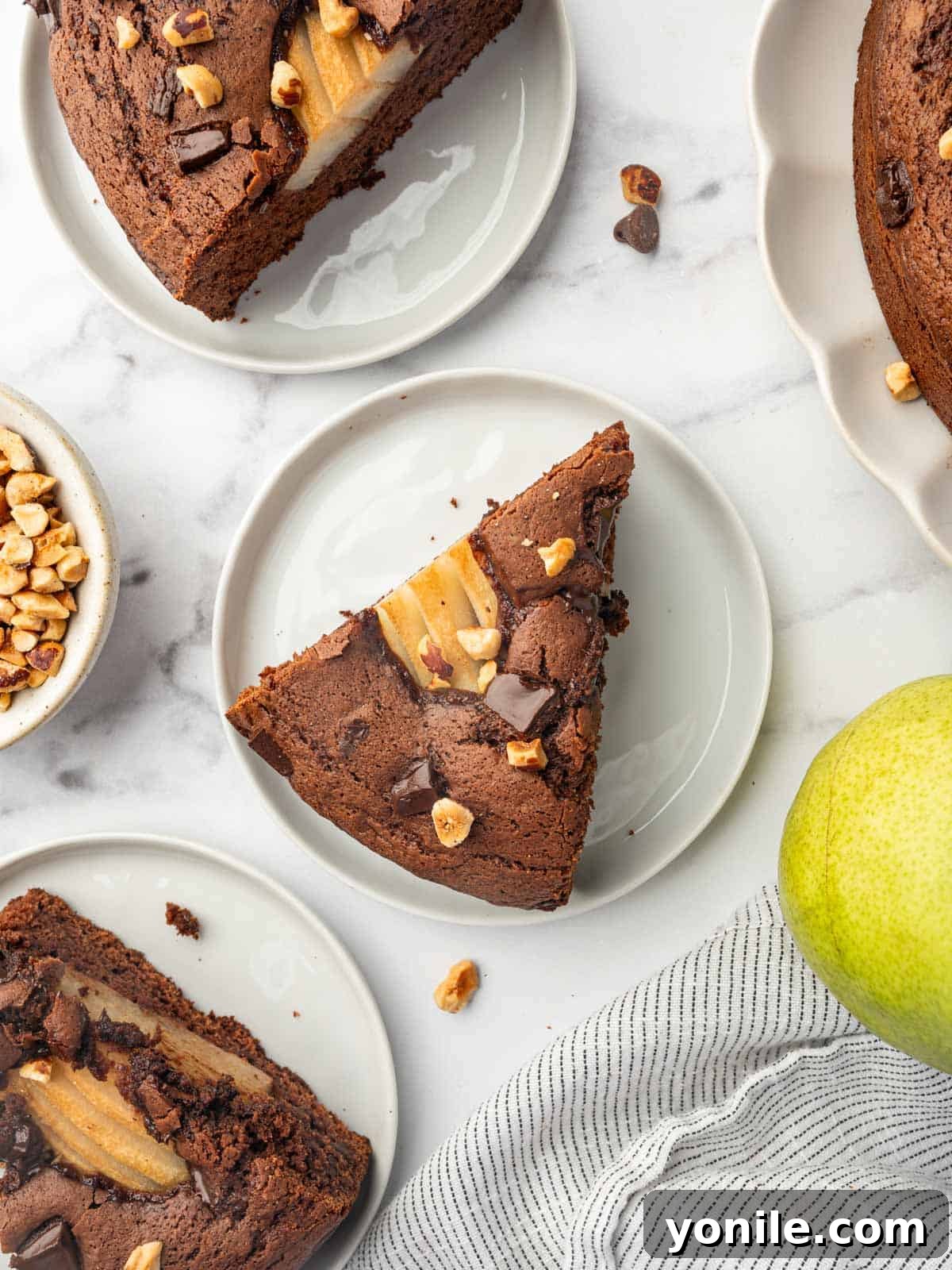 Individual slices of pear cake on plates, ready to be served.
