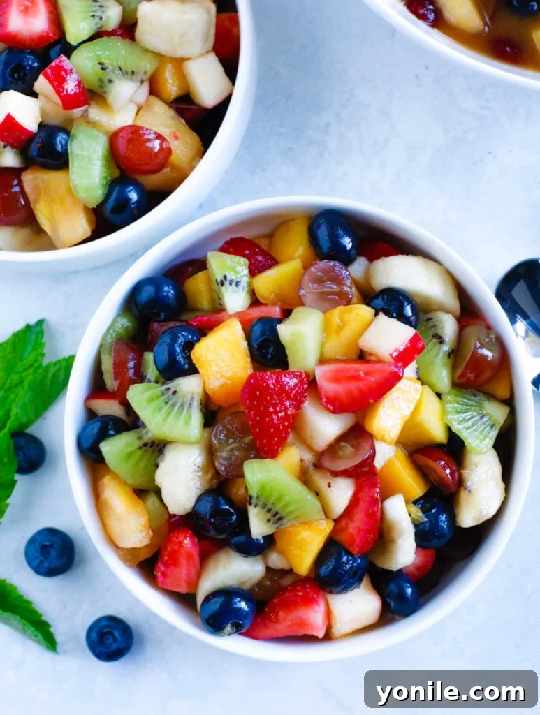 Delicious Fruit Salad Two bowls brimming with vibrant, colorful fruit salad, ready to be enjoyed.