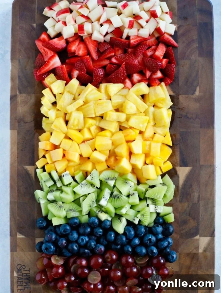 Effortless Fruit Fiesta 2 Various fresh fruits, perfectly chopped into uniform chunks, ready for mixing in a fruit salad.