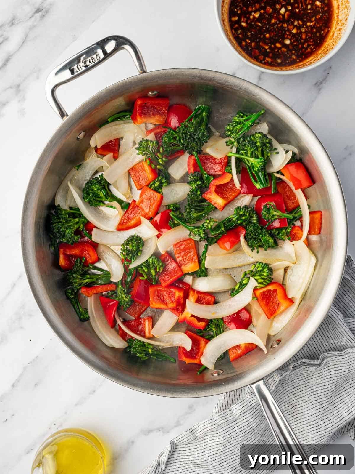 Panda Express Wok-Fired Sizzling Shrimp 7 Freshly cut onions, bell peppers, and baby broccoli being stir-fried in a skillet until tender-crisp.