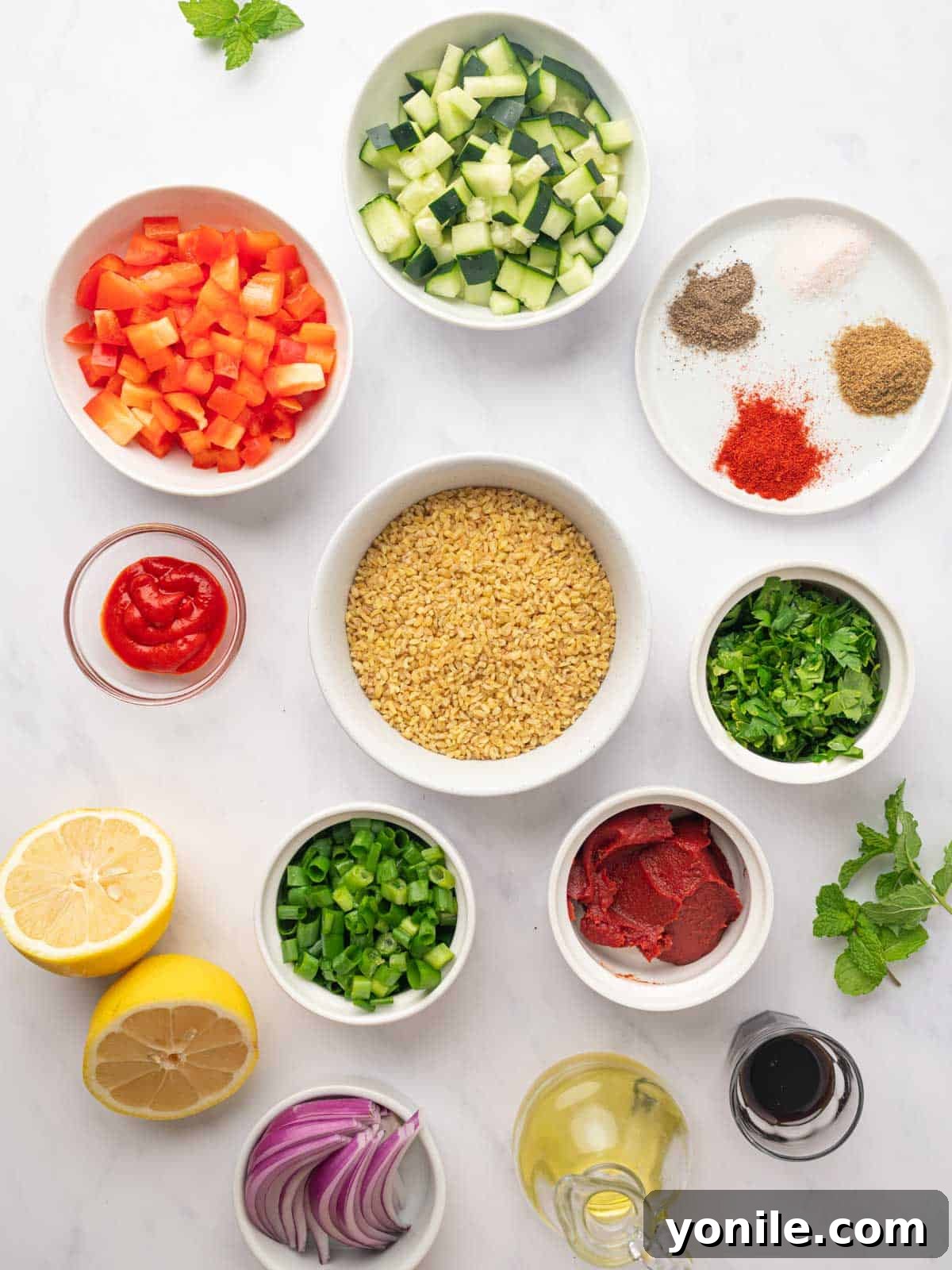 Vibrant Turkish Kisir Salad 2 A vibrant display of fresh ingredients for Turkish bulgur salad, Kisir, including bulgur, diced vegetables, various herbs, and dressing components laid out on a clean surface.