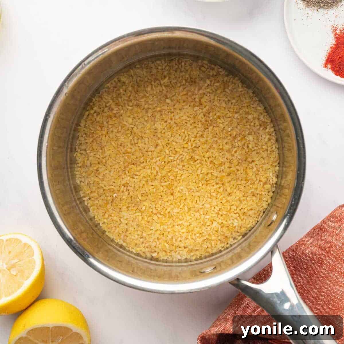 Vibrant Turkish Kisir Salad 3 Rinsed coarse bulgur wheat being added to a pot of boiling water, steam gently rising, in preparation for cooking.