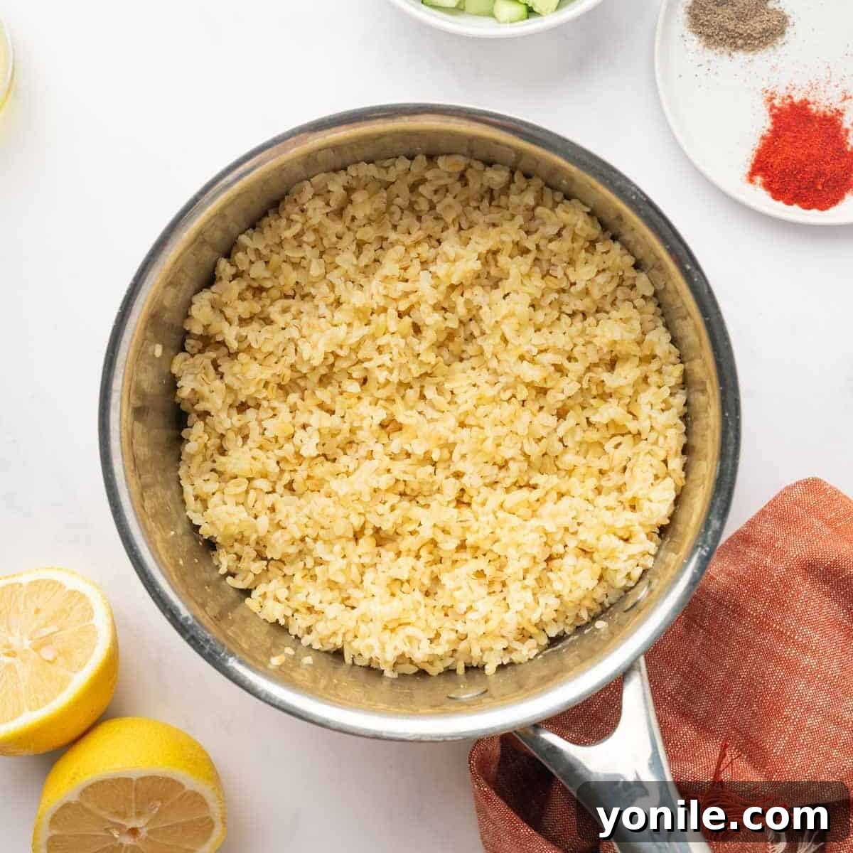 Vibrant Turkish Kisir Salad 4 Cooked bulgur wheat, perfectly fluffed with a fork in the pot, allowing steam to escape and grains to separate before cooling.