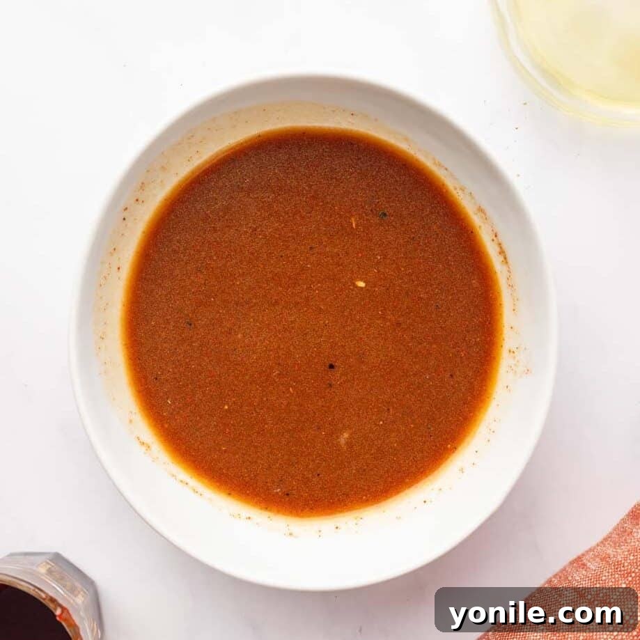Vibrant Turkish Kisir Salad 5 All the vibrant ingredients for the Kisir salad dressing being whisked vigorously in a small bowl to ensure a smooth, well-combined mixture.