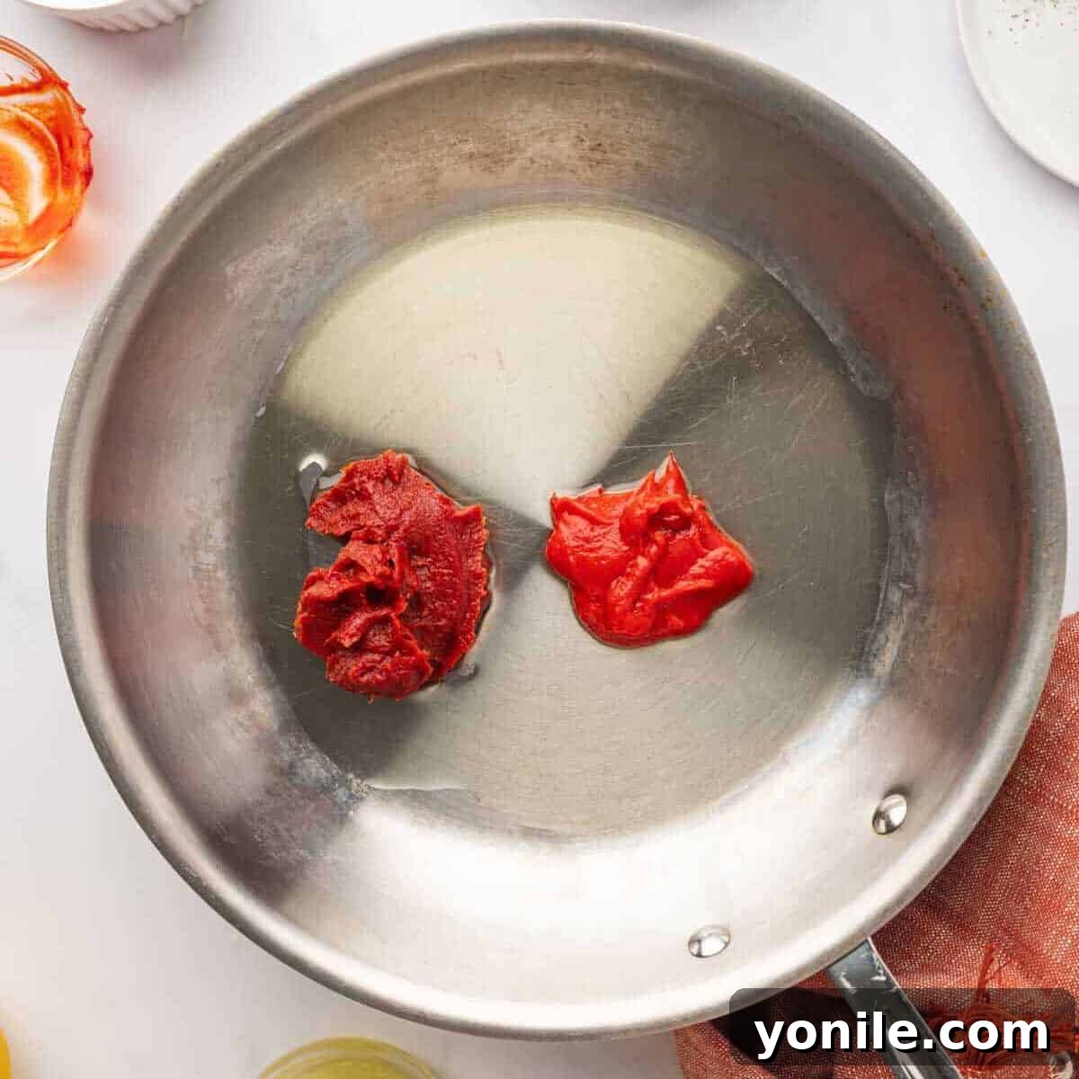 Vibrant Turkish Kisir Salad 6 The rich, red tomato paste and red pepper paste mixture gently simmering in a shallow pan with olive oil, developing depth of flavor.