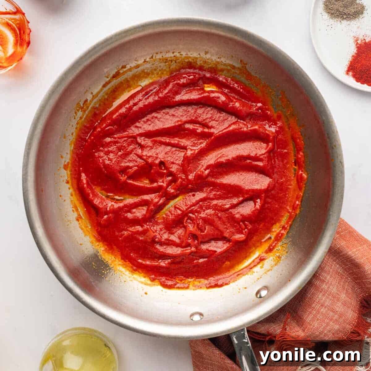 Vibrant Turkish Kisir Salad 7 The cooked tomato paste and red pepper paste mixture in a pan, glistening and ready after simmering, with a small amount of water added for smooth consistency.