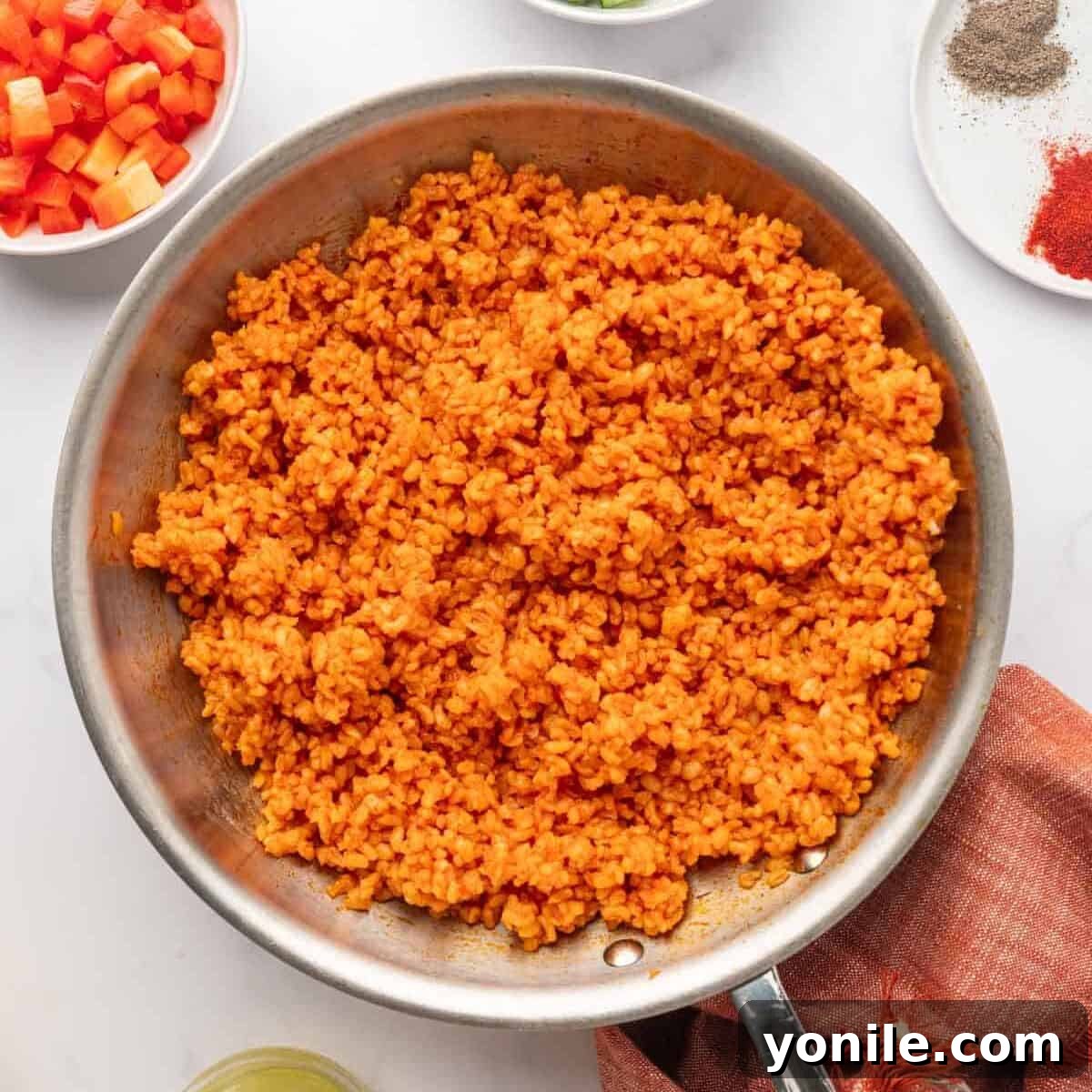 Vibrant Turkish Kisir Salad 9 The cooked bulgur thoroughly mixed with the tomato and red pepper sauce, now resting and cooling in the pan before the fresh vegetables are added.