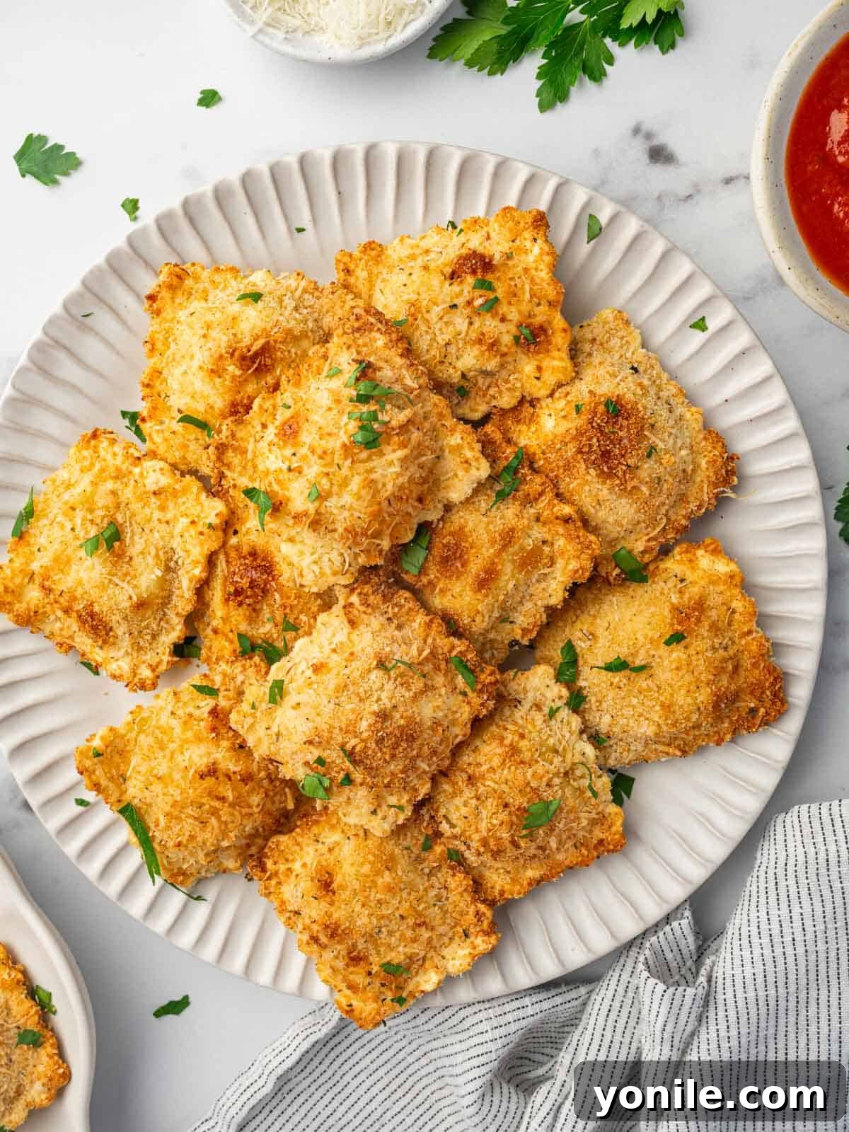 Crispy Air Fryer Ravioli 10 Air fryer ravioli on a plate.