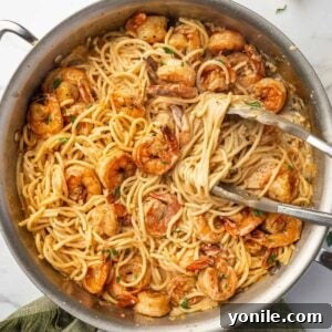 Fiery Cajun Shrimp Scampi with Linguine 12 Tongs scoop up a serving of cajun shrimp pasta.