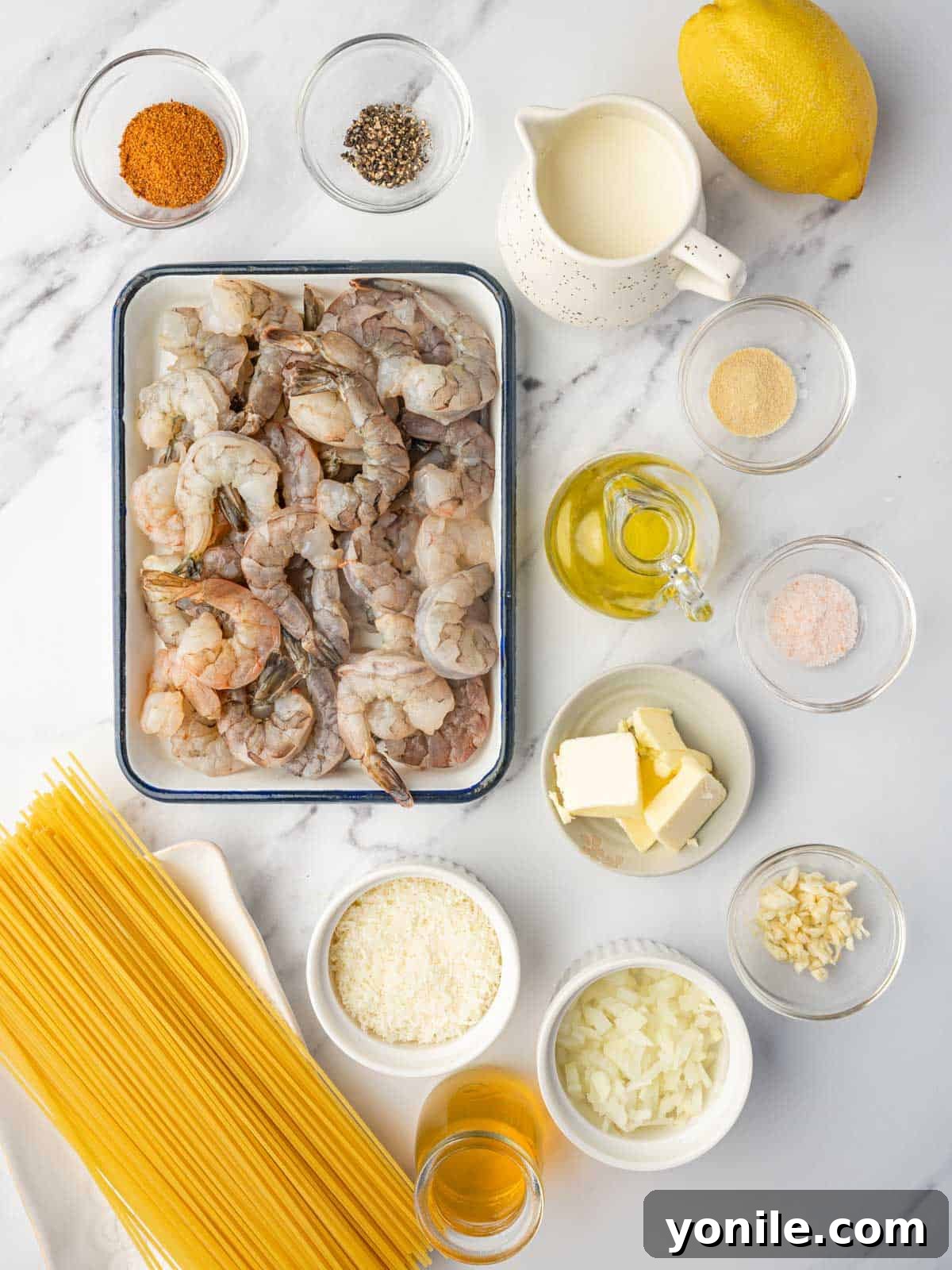 Fiery Cajun Shrimp Scampi with Linguine 3 Ingredients needed for cajun shrimp scampi laid out on a table.