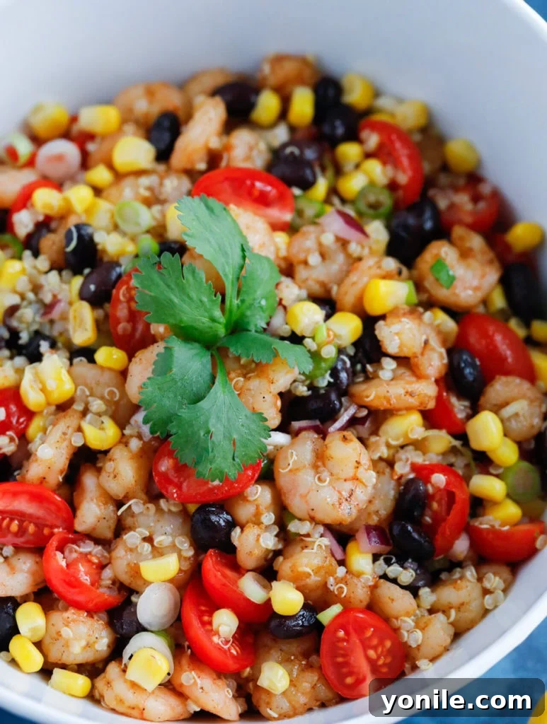 A large bowl of Southwest Shrimp Quinoa Salad, mixed and ready to serve