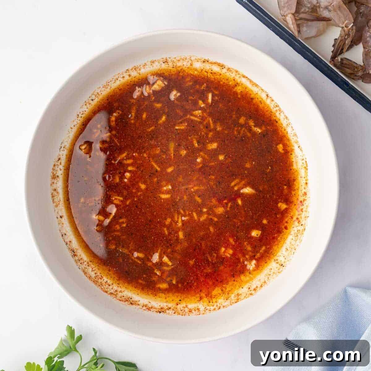 Grilled cajun shrimp marinade in a bowl, showing the blended spices and oil.