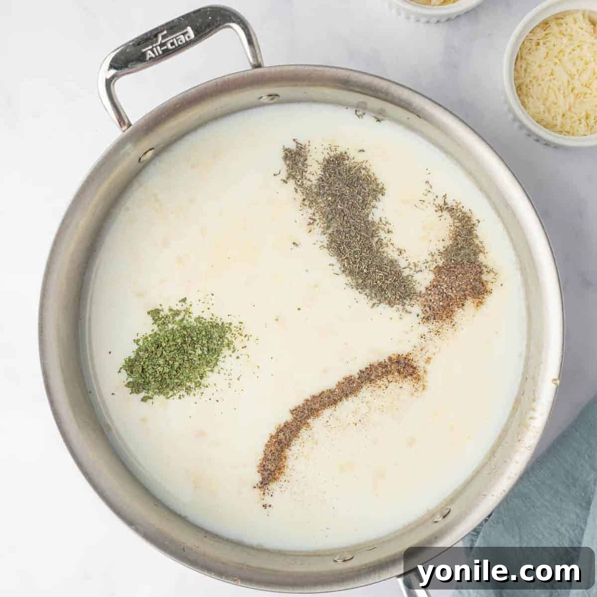 Creamy Cheese Tortellini Alfredo 6 All-purpose flour being stirred into a mixture of melted butter and garlic in a skillet to form a roux.