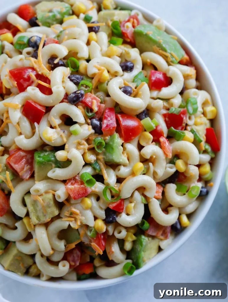 A large serving bowl of Taco Ranch Pasta Salad, perfectly chilled and ready to be enjoyed, showcasing its vibrant ingredients and creamy texture.